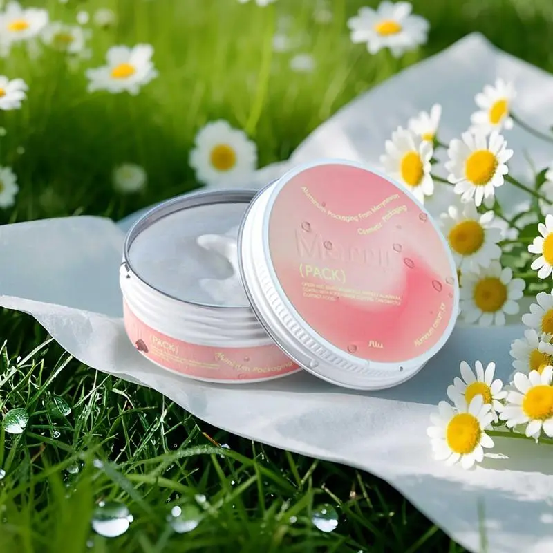 cream balm jar open on white paper amidst grassy field with daisies and dew drops.(1).jpg
